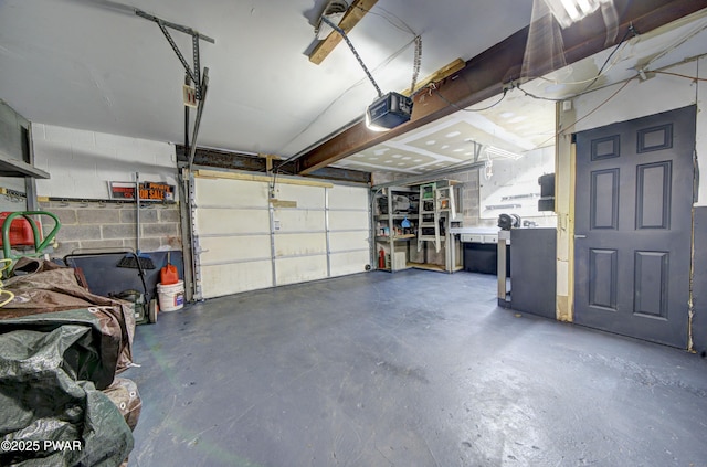 garage with concrete block wall and a garage door opener