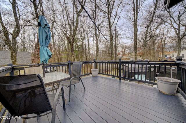 wooden terrace with outdoor dining area