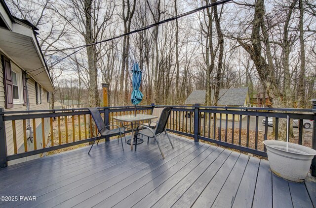 wooden deck featuring outdoor dining area