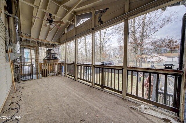 unfurnished sunroom featuring a wealth of natural light and a ceiling fan