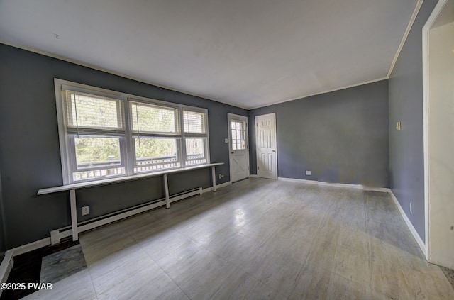 unfurnished room featuring baseboards and a baseboard heating unit