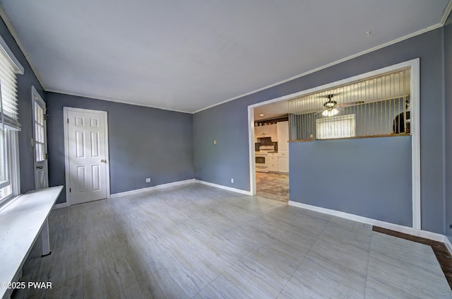 interior space featuring crown molding, a wealth of natural light, and baseboards