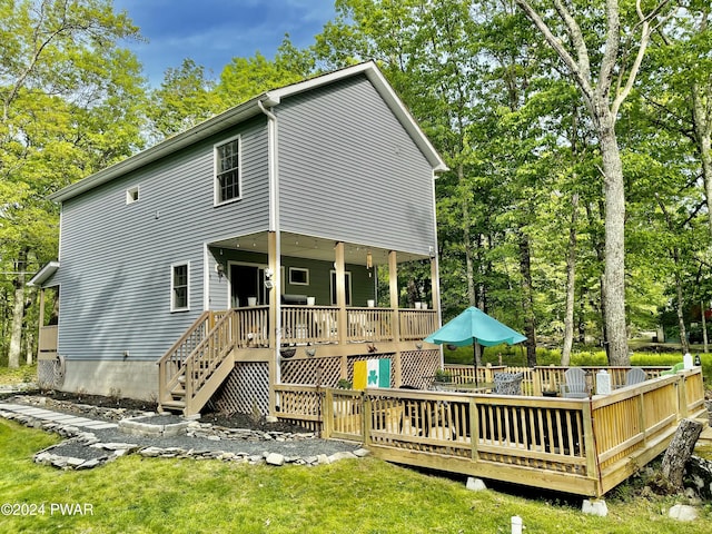 rear view of property with a wooden deck