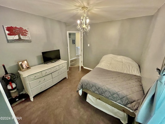 carpeted bedroom featuring a notable chandelier