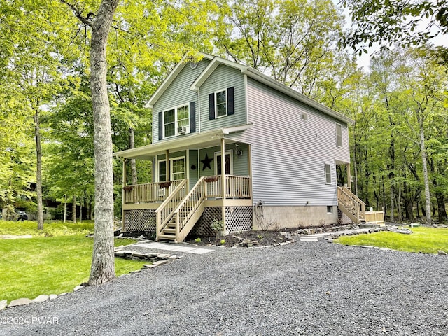 view of front of house with a porch and a front yard