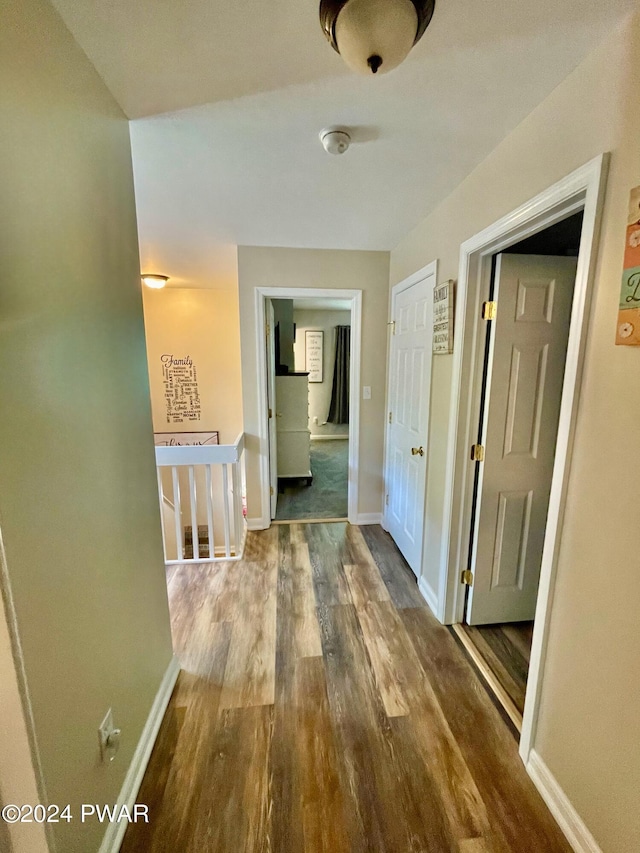 hallway with dark hardwood / wood-style floors