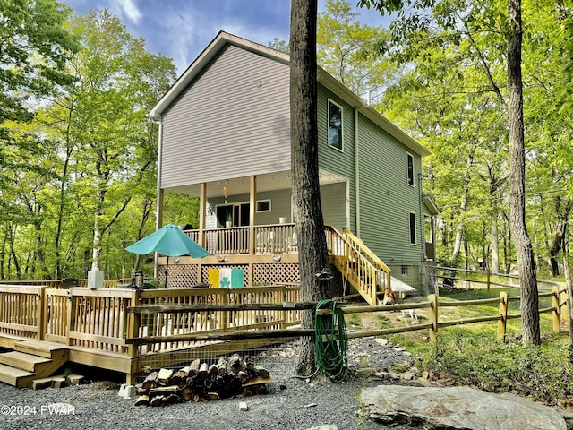 rear view of house featuring a wooden deck