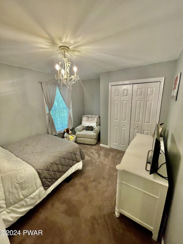 carpeted bedroom featuring a closet and a chandelier