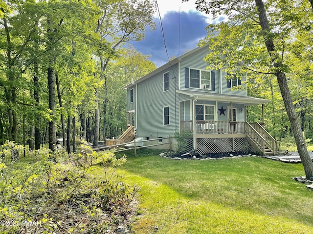 back of property featuring a lawn and a porch