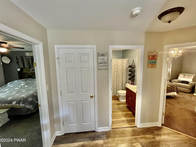 interior space featuring hardwood / wood-style flooring and an inviting chandelier