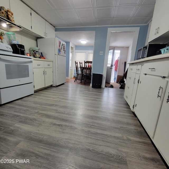 kitchen with white cabinetry, extractor fan, white appliances, and light hardwood / wood-style flooring