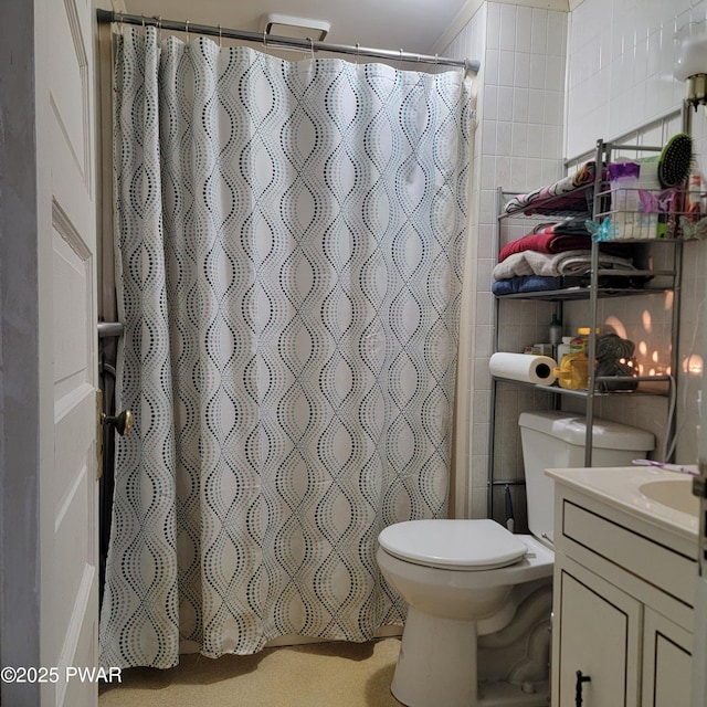 bathroom featuring vanity, tile walls, curtained shower, and toilet