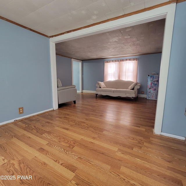 interior space with crown molding and light wood-type flooring