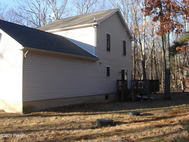 113 Oak Dr, Shohola, PA 18458 - view of side of property with a shingled roof, a deck, and a yard