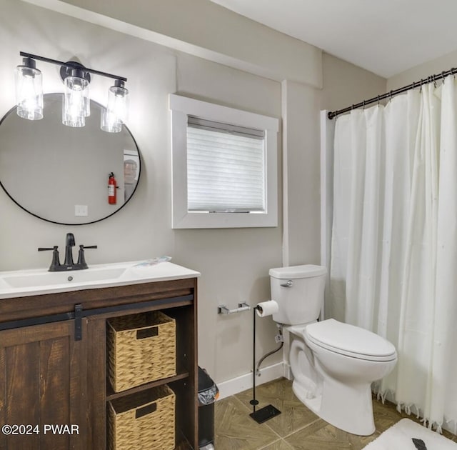 bathroom featuring vanity, curtained shower, and toilet