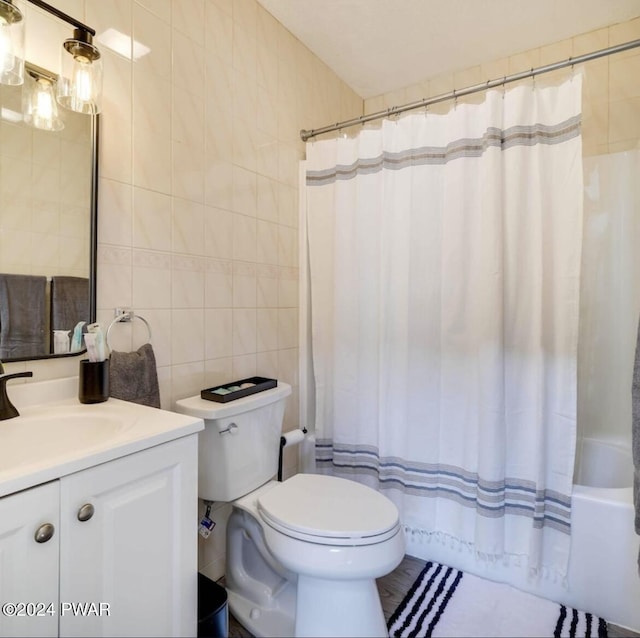 full bathroom featuring tasteful backsplash, vanity, shower / bathtub combination with curtain, tile walls, and toilet