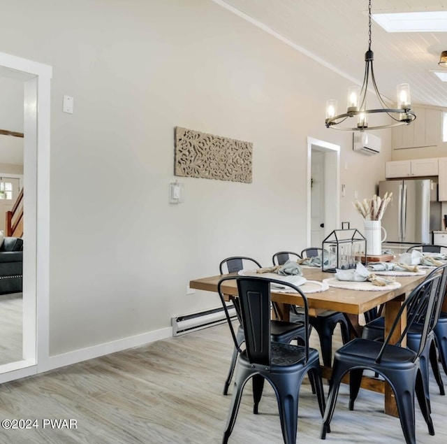 dining room featuring a notable chandelier, light wood-type flooring, baseboard heating, and a wall mounted AC