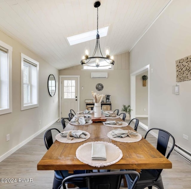 dining space featuring light hardwood / wood-style flooring, a notable chandelier, an AC wall unit, vaulted ceiling with skylight, and wood ceiling