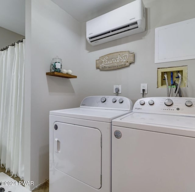 laundry area featuring washer and clothes dryer and a wall mounted air conditioner