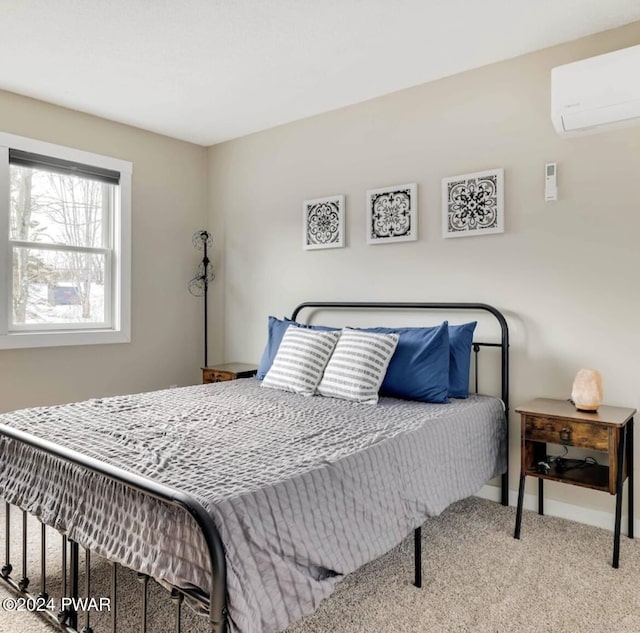 bedroom featuring an AC wall unit and light colored carpet