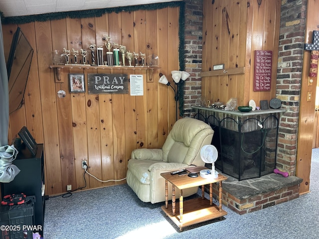 201 Oak Hill Rd, Hawley, PA 18428 - living area featuring carpet flooring, wooden walls, and a brick fireplace