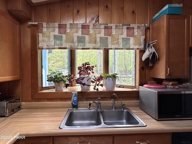 201 Oak Hill Rd, Hawley, PA 18428 - kitchen with stainless steel microwave, a sink, light countertops, and brown cabinets