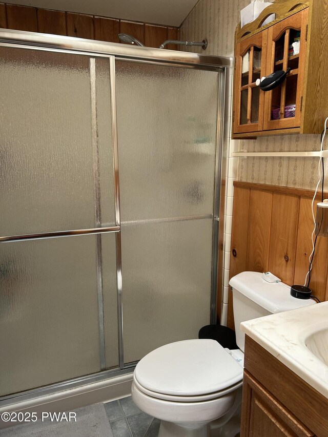 201 Oak Hill Rd, Hawley, PA 18428 - full bathroom with a stall shower, toilet, vanity, and tile patterned floors