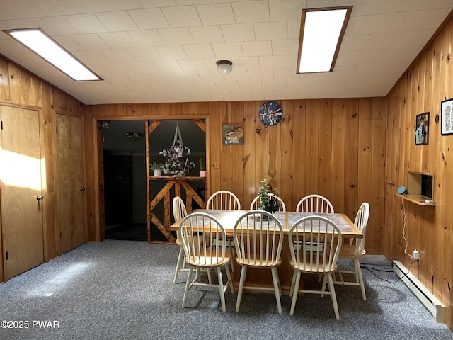 201 Oak Hill Rd, Hawley, PA 18428 - dining area featuring a baseboard radiator, carpet, and wooden walls