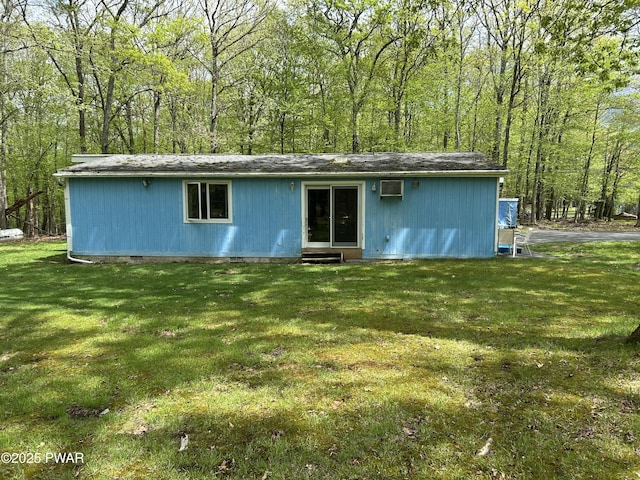 201 Oak Hill Rd, Hawley, PA 18428 - rear view of house featuring a yard and a wall mounted air conditioner