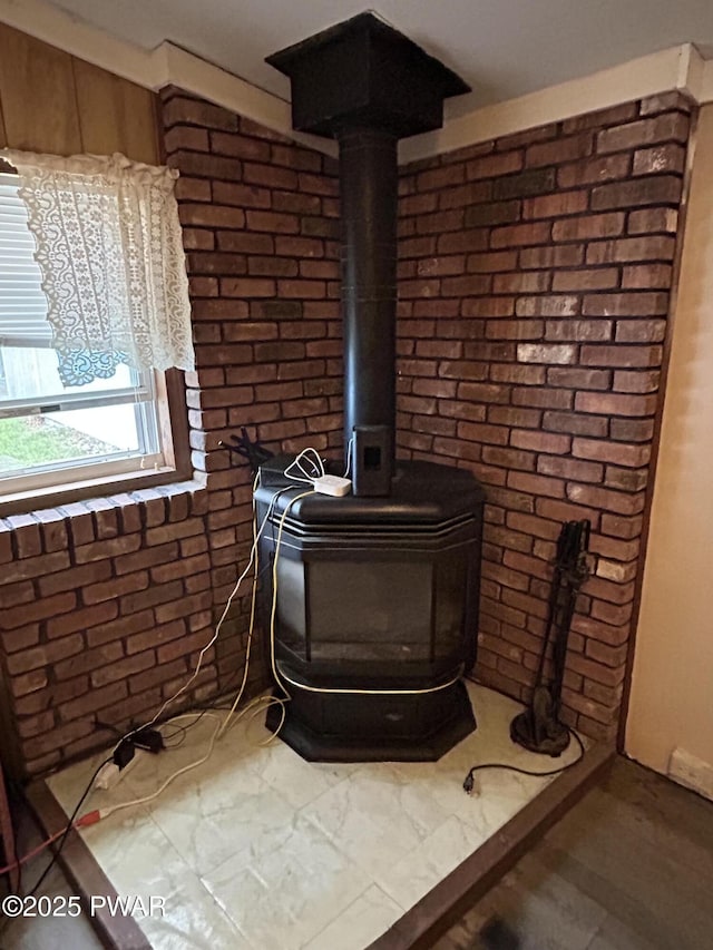 201 Oak Hill Rd, Hawley, PA 18428 - detailed view of a wood stove, brick wall, and wood finished floors