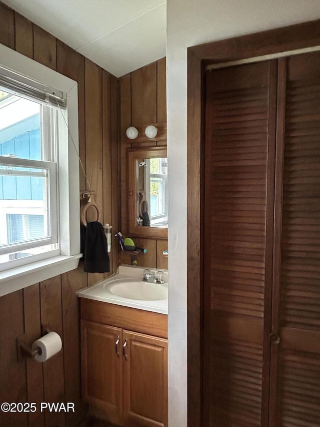 201 Oak Hill Rd, Hawley, PA 18428 - bathroom featuring plenty of natural light, vanity, and wood walls