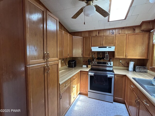 201 Oak Hill Rd, Hawley, PA 18428 - kitchen featuring stainless steel range with electric cooktop, under cabinet range hood, light countertops, a ceiling fan, and a sink
