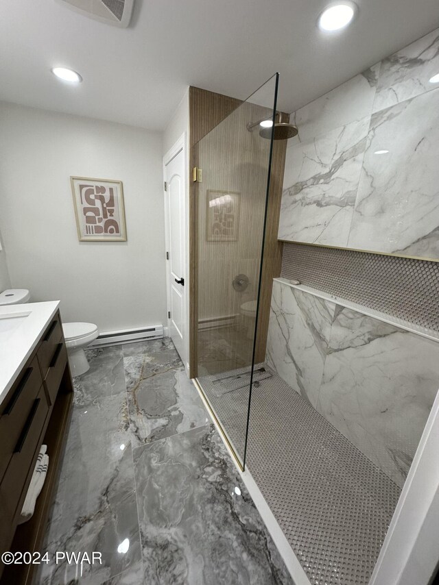 bathroom featuring a tile shower, toilet, vanity, and baseboard heating