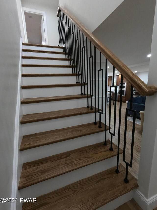 stairs featuring hardwood / wood-style flooring