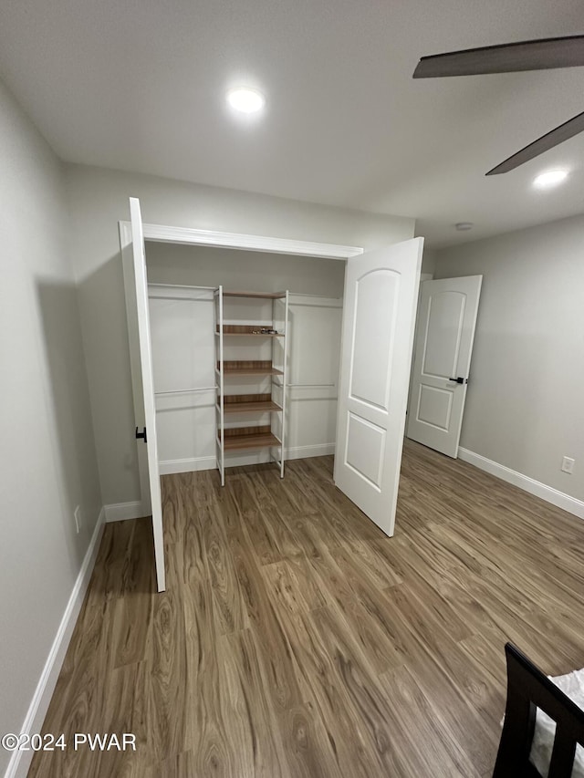 unfurnished bedroom with a closet and hardwood / wood-style floors