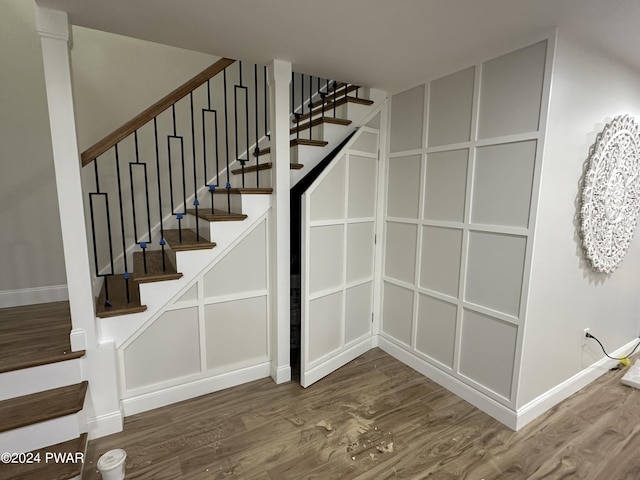 stairs featuring hardwood / wood-style flooring