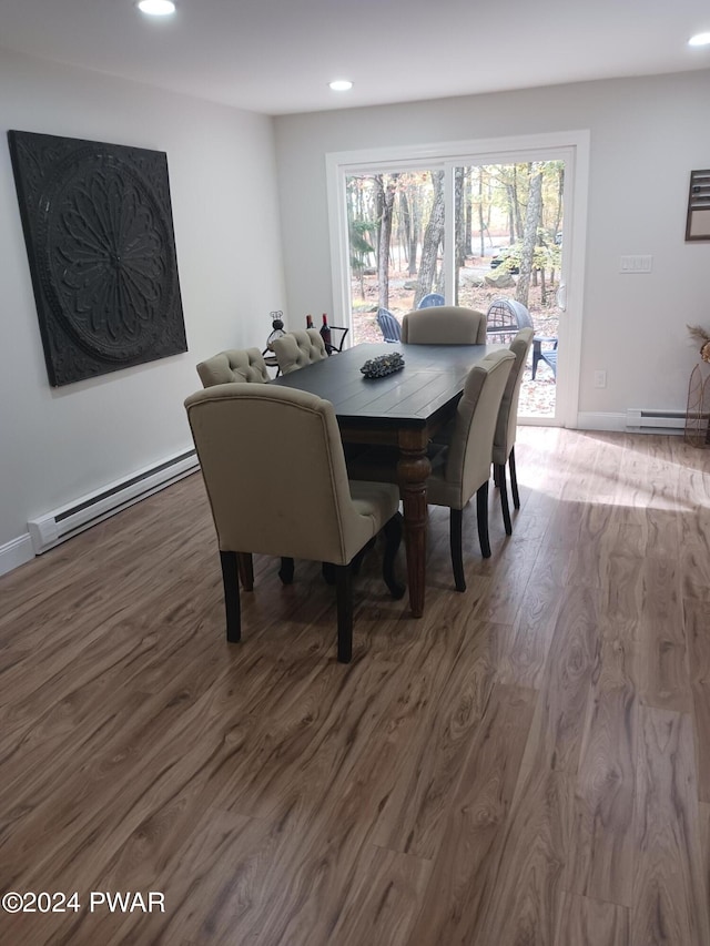 dining area with wood-type flooring and a baseboard radiator