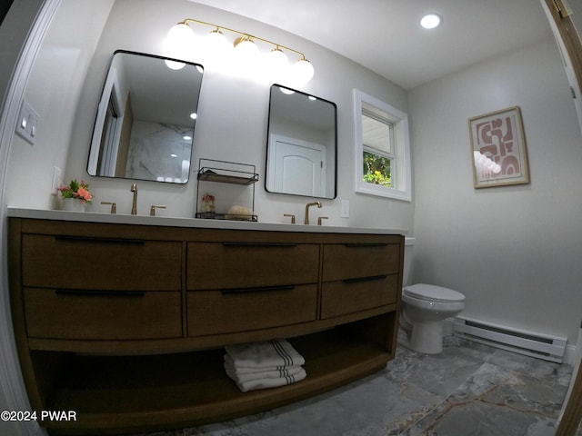 bathroom with baseboard heating, vanity, and toilet