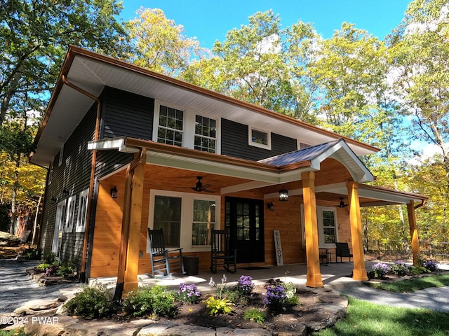 rear view of property with ceiling fan