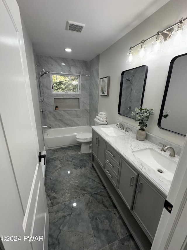 full bathroom featuring vanity, toilet, and tiled shower / bath combo