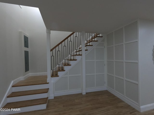 stairway featuring wood-type flooring