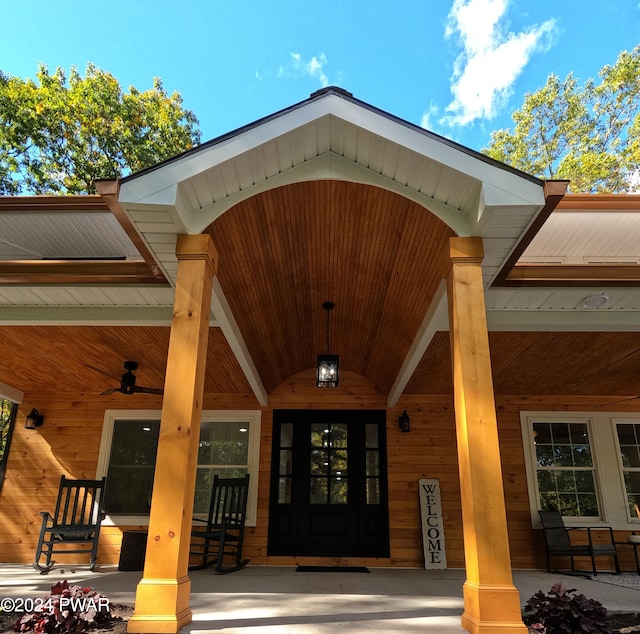 entrance to property with ceiling fan and covered porch