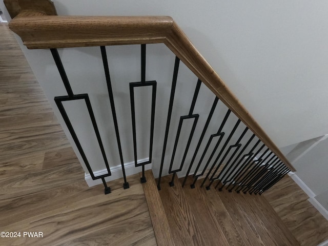 staircase with wood-type flooring