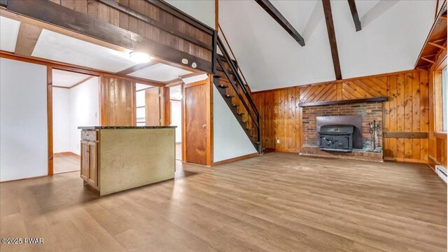 122 Westfall Dr, Dingmans Ferry, PA 18328 - unfurnished living room with stairs, wood finished floors, baseboards, a wood stove, and wooden walls