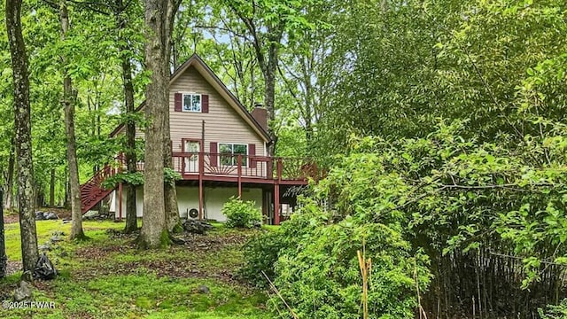 122 Westfall Dr, Dingmans Ferry, PA 18328 - rear view of property featuring a deck, a chimney, and stairs
