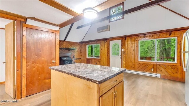 122 Westfall Dr, Dingmans Ferry, PA 18328 - kitchen with a baseboard radiator, light wood finished floors, plenty of natural light, a kitchen island, and wooden walls