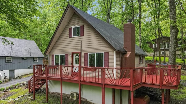 122 Westfall Dr, Dingmans Ferry, PA 18328 - back of house featuring a chimney, a wooden deck, a shingled roof, and a cooling unit