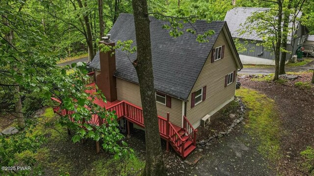 122 Westfall Dr, Dingmans Ferry, PA 18328 - view of side of property with a shingled roof and a deck
