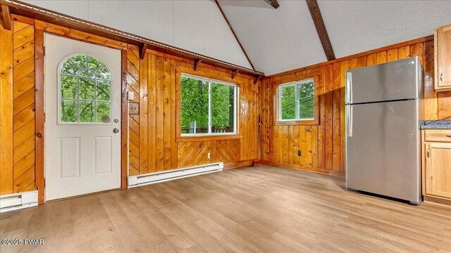 122 Westfall Dr, Dingmans Ferry, PA 18328 - entryway featuring baseboard heating, plenty of natural light, light wood-type flooring, and wooden walls