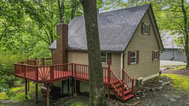 122 Westfall Dr, Dingmans Ferry, PA 18328 - rear view of property with roof with shingles, a wooden deck, and a chimney